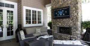 Luxury Residential Outdoor audio and Visual with a TV Mounted on Stone