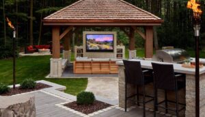 Outdoor lighting and audio visual with a luxury Grill and an outdoor TV
